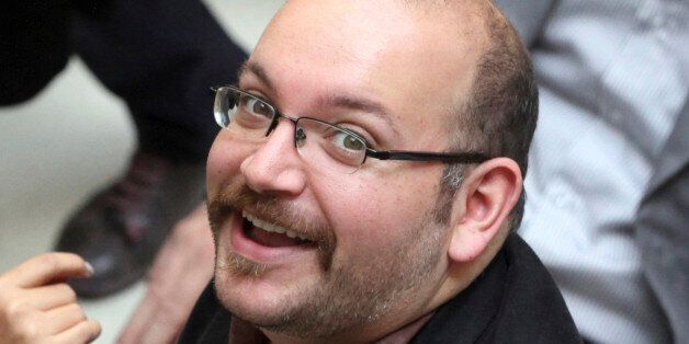 FILE - In this photo April 11, 2013 file photo, Jason Rezaian, an Iranian-American correspondent for the Washington Post, smiles as he attends a presidential campaign of President Hassan Rouhani in Tehran, Iran. Iran's official IRNA news agency reported that the verdict against Rezaian has been issued. Rezaian, the Post's Tehran bureau chief, is accused of charges including espionage in a closed-door trial that has been widely criticized by the U.S. government and press freedom organizations. (A