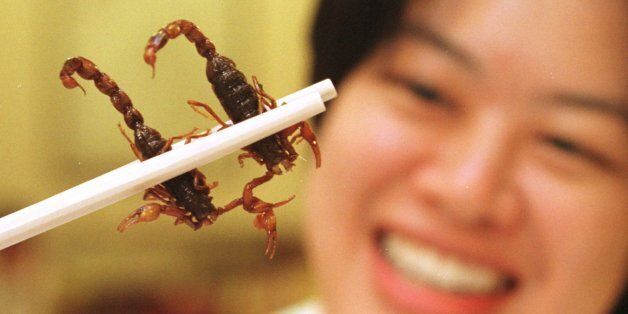 --Singaporean diner Sum June-wei holds two scorpions between her chopsticks at the Imperial Herbal Restaurant in Singapore Jan. 25, 1996.  The scorpions, imported from China, cost $4 each in a dish called