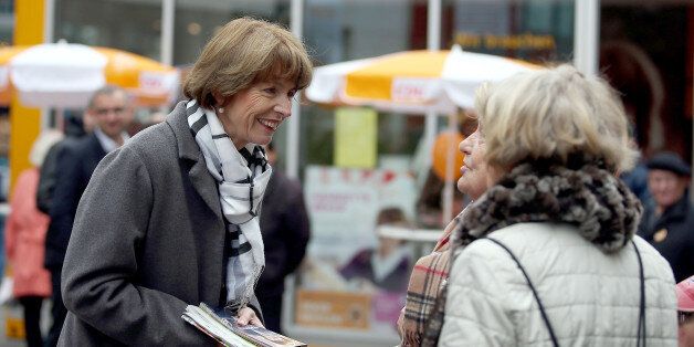 In this Friday, Oct. 16, 2015 photo independent candidate for the mayor of Cologne Henriette Reker talks to residents during her election campaign in Cologne, Germany. Reker was wounded in a stabbing as she campaigned on Saturday, Oct. 17, 2015, a day before an election in the western German city. (Oliver Berg/dpa via AP)