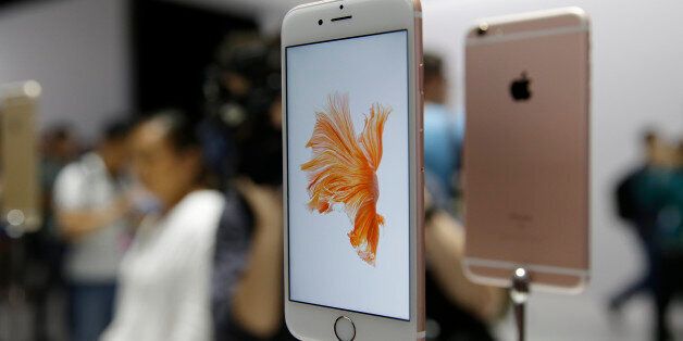 People look over the new Apple iPhone 6s models during a product display following an Apple event Wednesday, Sept. 9, 2015, in San Francisco. (AP Photo/Eric Risberg)
