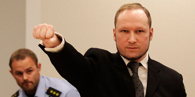 FOR USE AS DESIRED, YEAR END PHOTOS - FILE - In this Aug. 24, 2012 file photo, mass murderer Anders Behring Breivik, makes a salute after arriving in the court room at a courthouse in Oslo.   Breivik, who admitted killing 77 people in Norway last year, was declared sane and sentenced to prison for bomb and gun attacks. (AP Photo/Frank Augstein, File)