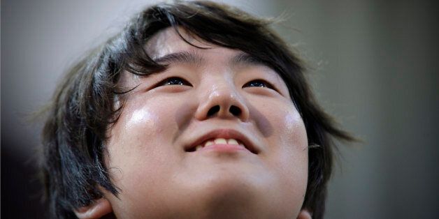 Jin Cho of Korea reacts after playing piano during the third round of XIV International Tchaikovsky Competition in Moscow,  Russia, Wednesday, June 29, 2011.(AP Photo/Alexander Zemlianichenko)