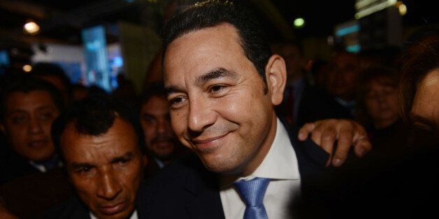 Jimmy Morales, the National Front of Convergence party presidential candidate, arrives to the Electoral Supreme Court headquarters in Guatemala City, Sunday, Oct. 25, 2015. Morales, a TV comedian, was elected as Guatemala's next president in a landslide Sunday, riding a wave of popular anger against the political class after huge anti-corruption protests helped oust the last government. (AP Photo/Oliver de Ros)