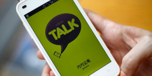 In this Aug. 20, 2012 photo, a woman opens Kakao Talk, a South Korean mobile messaging app with more than 60 million users, on her smartphone in Seoul, South Korea. A handful of smartphone apps that began as basic instant messaging services have amassed several hundred million users in Asia in just a couple of years, mounting a challenge to the popularity of online hangouts such as Facebook as they branch into games, e-commerce, celebrity news and other areas. (AP Photo/Hye Soo Nah)