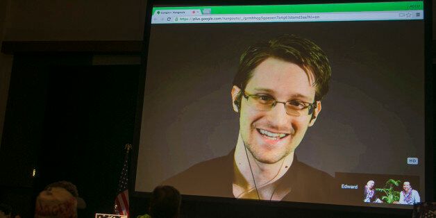 National Security Agency leaker Edward Snowden appears on a live video feed broadcast from Moscow at an event sponsored by the ACLU Hawaii in Honolulu on Saturday, Feb. 14, 2015. (AP Photo/Marco Garcia)