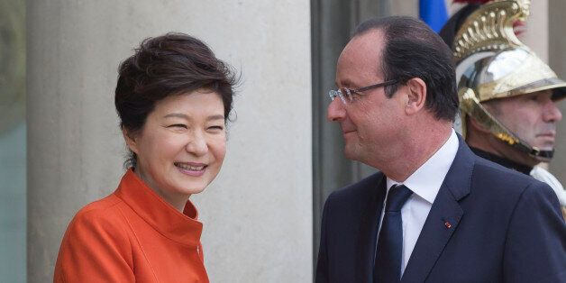 France's President Francois Hollande, right, poses for photographers with South Korean President Park Geun Hye at the Elysee Palace in Paris, Monday, Nov. 4, 2013. Park arrived in France as part of her weeklong trip to Western Europe including Britain and Belgium. This is the first time Park has been to France in 39 years, when she returned after six months of studying upon the assassination of her mother, first lady Yook Young-soo, in 1974. (AP Photo/Michel Euler)