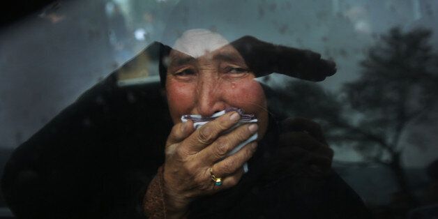 A Hazara tribeswoman cries in a car as thousands march through the Afghan capital of Kabul on Wednesday, Nov. 11, 2015, carrying the coffins of seven ethnic Hazaras who were allegedly killed by the Taliban and calling for a new government that can ensure security in the country. (AP Photos/Massoud Hossaini)