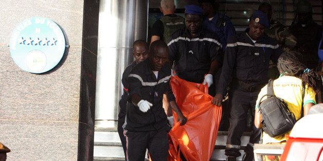 A body is removed from the  Radisson Blu hotel, after it was stormed by gunmen during a attack on the hotel in Bamako, Mali, Friday, Nov. 20, 2015. Islamic extremists armed with guns and grenades stormed the luxury Radisson Blu hotel in Mali's capital Friday morning, and security forces worked to free guests floor by floor.  (AP Photo/Harouna Traore)