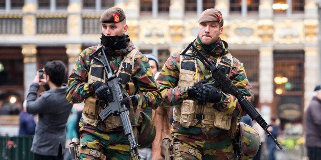 Belgian Army soldiers patrol in the picturesque Grand Place in the center of Brussels on Friday, Nov. 20, 2015.  Salah Abdeslam, a French national who lived in Molenbeek, Belgium, is currently the subject of an international manhunt after the Paris attacks. Security has been stepped up in parts of Belgium as a precaution. (AP Photo/Geert Vanden Wijngaert)