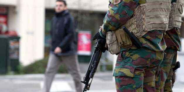 Belgian Army soldiers patrol outside EU headquarters in Brussels on Monday, Nov. 23, 2015. The Belgian capital Brussels has entered its third day of lockdown, with schools and underground transport shut and more than 1,000 security personnel deployed across the country. (AP Photo/Virginia Mayo)