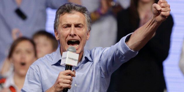 Opposition candidate Mauricio Macri celebrates after winning a runoff presidential election in Buenos Aires, Argentina, Sunday, Nov. 22, 2015.  Macri won Argentina's historic runoff election against ruling party candidate Daniel Scioli, putting an end to the era of  President Cristina Fernandez, who along with her late husband dominated Argentine politics for 12 years.  (AP Photo/Ricardo Mazalan)