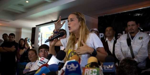 Lilian Tintori, center, wife of jailed opposition leader Leopoldo Lopez, speaks during a news conference in Caracas, Venezuela, Thursday, Nov. 26, 2015. An opposition leader was shot to death Wednesday while campaigning for next week's congressional elections in Venezuela, members of his political party said. The shooting took place in the central town of Altagracia de Orituco, said the leader of the Democratic Action Party, Carolos Prosperi. He said he heard gunshots as the rally was breaking u