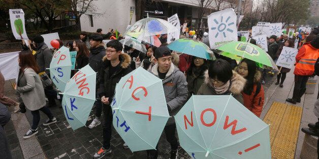 Environmental activists march during the Global Climate March in Seoul, South Korea, Sunday, Nov. 29, 2015. The march is part of a global campaign ahead of next week's U.N. climate talks in Paris. (AP Photo/Ahn Young-joon)