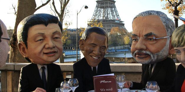 Oxfam activists wear masks  from left, of French President Francois Hollande, Chinese President Xi Jinping, U.S. President Barack Obama, India's Prime Minister Narendra Modi and German Chancellor Angela Merkel as they stage a protest ahead of the 2015 Paris Climate Conference, in Paris, Saturday, Nov. 28, 2015. Oxfam wants world leaders to get the best climate deal for poor people. (AP Photo/Thibault Camus)