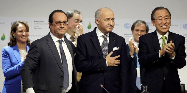 French Foreign Affairs Minister Laurent Fabius, center, President-designate of COP21, puts his hand over his heart after his speech as he stands near French President Francois Hollande, left, and United Nations Secretary-General Ban Ki-moon, right at the World Climate Change Conference 2015 (COP21) at Le Bourget, near Paris, France, Saturday, Dec. 12, 2015 . Negotiators from around the world appear to be closing in on a landmark accord to slow global warming, with a possible final draft to be pr