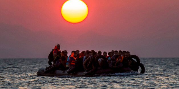 FOR USE AS DESIRED, YEAR END PHOTOS - FILE - Migrants on a dinghy arrives at the southeastern island of Kos, Greece, after crossing from Turkey, Thursday, Aug. 13, 2015. Greece has become the main gateway to Europe for tens of thousands of refugees and economic migrants, mainly Syrians fleeing war, as fighting in Libya has made the alternative route from north Africa to Italy increasingly dangerous. (AP Photo/Alexander Zemlianichenko, File)