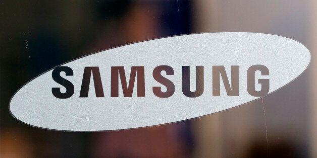 A logo of Samsung Electronics Co. is seen at its shop in Seoul, South Korea, Thursday, Oct. 29, 2015. Samsung Electronics Co. reported its first earnings gain in more than a year on Thursday as a record profit from computer chips masked a decline in its smartphone business. (AP Photo/Lee Jin-man)
