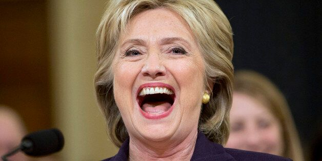 Democratic presidential candidate and former Secretary of State Hillary Rodham Clinton, laughs out loud after Rep. Martha Roby, R-Ala., asked Clinton if she was home alone during night of the 2012 Benghazi attacks during testimony on Capitol Hill in Washington, Thursday, Oct. 22, 2015, before the House Select Committee on Benghazi. After laughing out loud, Clinton said it was a bit of levity at 7:15 p.m., more than nine hours since the hearing began. She described conversations with other offici