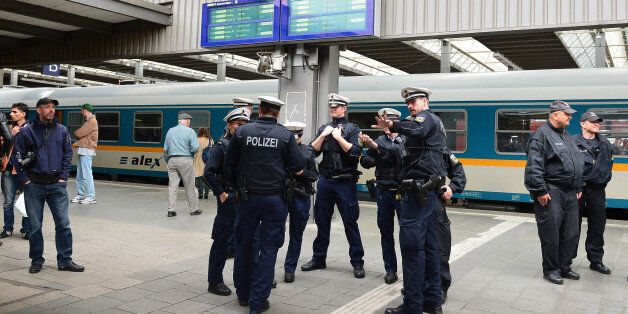 Police wait for the arrival of refugees at the main train station in Munich, Germany, Monday, Sept. 7, 2015. Refugees arrived in various trains to get first registration as asylum seekers in Germany.  (AP Photo/ Kerstin Joensson)