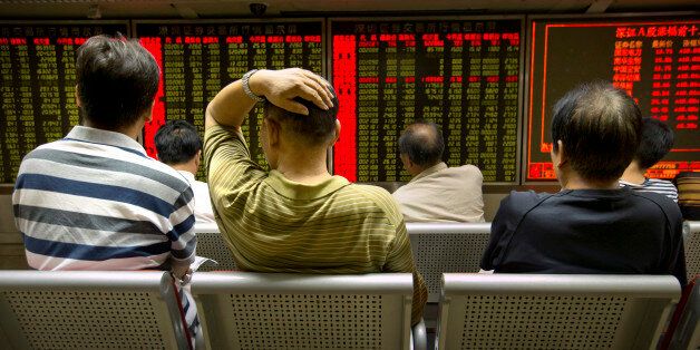 Chinese investors monitor stock prices at a brokerage house in Beijing, Tuesday, Aug. 18, 2015. The Shanghai Composite Index fell 6.2 percent on Tuesday as investors resumed sell-offs of Chinese stocks despite the stabilization of the Chinese yuan. (AP Photo/Mark Schiefelbein)