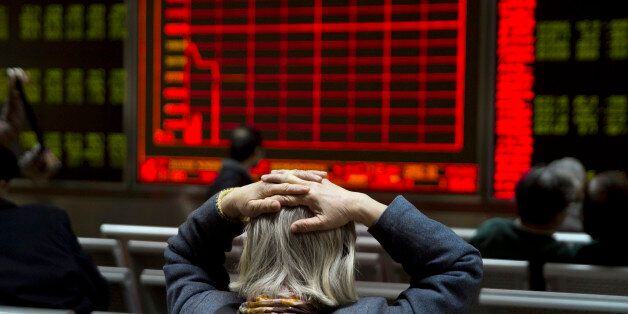 A woman reacts near a display board showing the plunge in the Shanghai Composite Index at a brokerage in Beijing, China, Thursday, Jan. 7, 2016. Chinese stocks nosedived on Thursday, triggering the second daylong trading halt of the week and sending other Asian markets sharply lower as investor jitters rippled across the region. (AP Photo/Ng Han Guan)