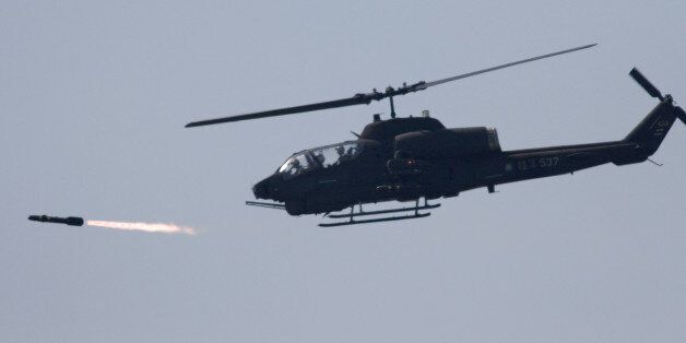 A U.S. made AH-1W attack helicopter launches a Hellfire missile during the annual Han Kuang No. 22 exercises, Thursday, July 20, 2006, in  Ilan, 80 kilometers (49 miles) west of Taipei, Taiwan. The goal of the exercises is to test the joint combat capability of the Taiwanese armed forces to fend off a Chinese offensive. Taiwan split from China in 1949 amid civil war and China hasn't ruled out the use of force to unify the island. (AP Photo)