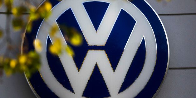 FILE - This Oct. 5, 2015 file photo shows the Volkswagen logo at the building of a company retailer in Berlin, Germany. Volkswagen almost inevitably will have to compensate owners of diesel cars equipped with emissions-rigging software. Some legal experts say the automaker could be forced to buy back the cars altogether. (AP Photo/Markus Schreiber, File)