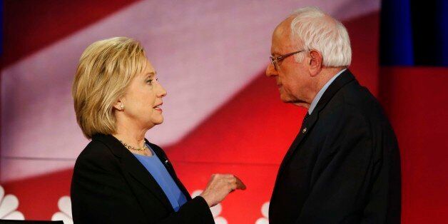 Democratic presidential candidate, Hillary Clinton and Democratic presidential candidate, Sen. Bernie Sanders, I-Vt. speak during a break at the NBC, YouTube Democratic presidential debate at the Gaillard Center, Sunday, Jan. 17, 2016, in Charleston, S.C. (AP Photo/Mic Smith)