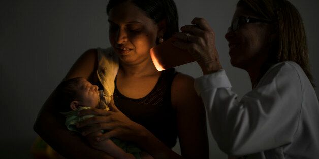 Daniele Ferreira dos Santos holds her son Juan Pedro as he undergoes visual exams at the Altino Ventura foundation in Recife, Pernambuco state, Brazil, Thursday, Jan. 28, 2016. Santos is at the epicenter of the Zika outbreak, and Pedroâs is among 3,400 suspected cases of microcephaly that may be connected to the virus, though no link has yet been proven. (AP Photo/Felipe Dana)
