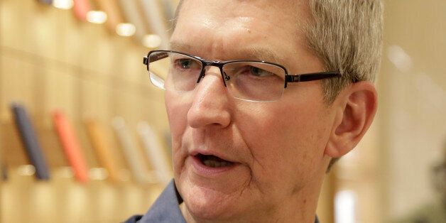 Apple CEO Tim Cook visits the Upper East Side Apple Store, Wednesday, Dec. 9, 2015, in New York. (AP Photo/Mark Lennihan)