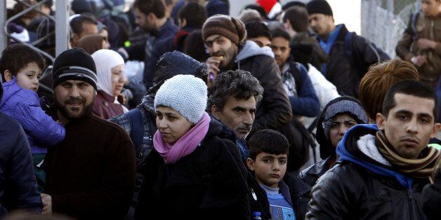 Refugees gather upon their arrival at the transit center for refugees near northern Macedonian village of Tabanovce, before continuing their journey to Serbia, Friday, Feb. 12, 2016. In a dramatic response to Europe's gravest refugee crisis since World War II, NATO ordered three warships to sail immediately Thursday to the Aegean Sea to help end the deadly smuggling of asylum-seekers across the waters from Turkey to Greece. (AP Photo/Boris Grdanoski)