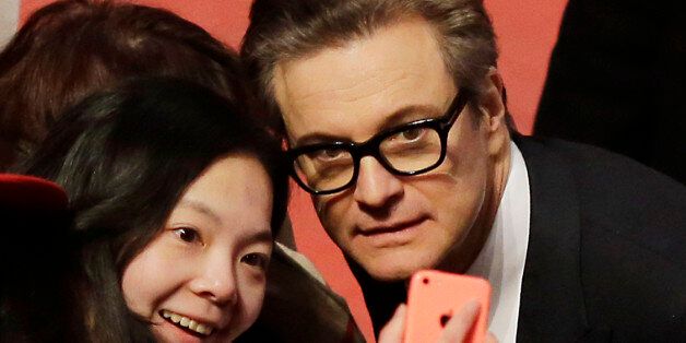Actor Colin Firth poses for photographs with fans upon arrival at the red carpet of the film 'Genius' during the 2016 Berlinale Film Festival in Berlin, Tuesday, Feb. 16, 2016. (AP Photo/Markus Schreiber)