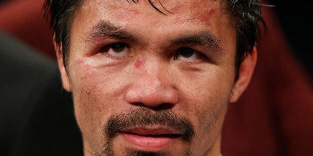 Manny Pacquiao, from the Philippines, waits after the welterweight title fight against Floyd Mayweather Jr., on Saturday, May 2, 2015 in Las Vegas.  (AP Photo/John Locher)