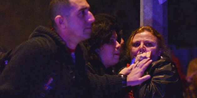 People react at the scene of an explosion in Ankara, Wednesday, Feb. 17, 2016. A large explosion, believed to have been caused by a bomb, injured several people in the Turkish capital on Wednesday, according to media reports. (IHA via AP) TURKEY OUT