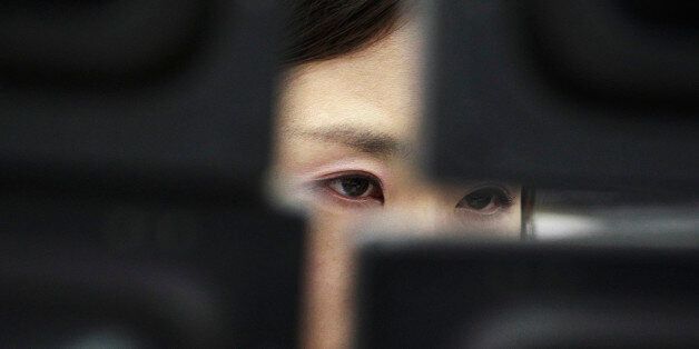 FILE - In this Tuesday, Feb. 4, 2014, file photo, a currency trader watches monitors at the Korea Exchange Bank headquarters in Seoul, South Korea. The Treasury Department reports on foreign holdings of U.S. debt for November 2015, on Tuesday, Jan. 19, 2016. (AP Photo/Ahn Young-joon, File)