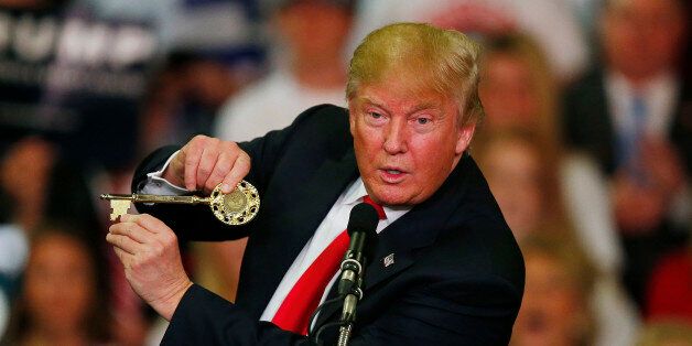 Republican presidential candidate Donald Trump holds up a key to the city he brought onto stage with him as he speaks at a campaign rally Monday, March 7, 2016, in Madison, Miss. (AP Photo/Brynn Anderson)