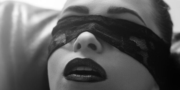 woman portrait blindfolded, black and white.