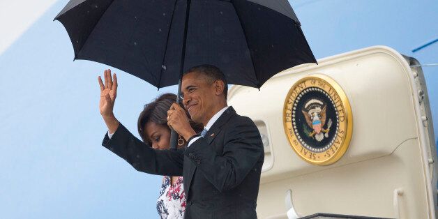 President Barack Obama, right, arrives with first lady Michelle Obama as they exit Air Force One at the airport in Havana, Cuba, Sunday, March 20, 2016. Obama's trip is a crowning moment in his and Cuban President Raul Castro's ambitious effort to restore normal relations between their countries. (AP Photo/Pablo Martinez Monsivais)