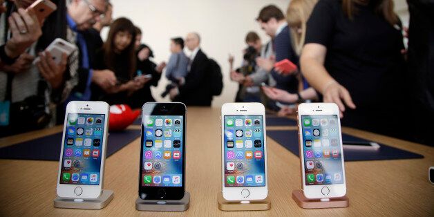Members of the media and invited guests take a look at the new iPhone SE during an event at Apple headquarters Monday, March 21, 2016, in Cupertino, Calif. (AP Photo/Marcio Jose Sanchez)