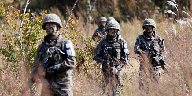 South Korean Army soldiers patrol during the demonstration of search operation at a training field near the demilitarized zone (DMZ) in Cheorwon, South Korea, Tuesday, Oct. 13, 2015. South Korea and North Korea are still technically at war because the 1950-53 Korean War ended with an armistice, not a peace treaty. (AP Photo/Lee Jin-man)