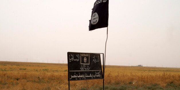 Islamic State group's flag is seen in an area after Kurdish troops known as peshmerga regained control of some villages west of the oil-rich city of Kirkuk, 180 miles (290 kilometers) north of Baghdad, Iraq, Wednesday, Sept. 30, 2015. Kurdish fighters in northern Iraq drove the IS group from more than 140 sq. kilometers (54 sq. miles) of territory near Kirkuk and cleared part of a major highway on Wednesday. (AP Photo)
