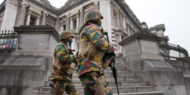 Belgium soldiers patrol around the main court building where Salah Abdeslam, the top suspect in last year's deadly Paris attacks, was expected to appear before a judge in Brussels, Belgium, Thursday, March 24, 2016. The Islamic State group has trained at least 400 fighters to target Europe in deadly waves of attacks, deploying interlocking terror cells like the ones that struck Brussels and Paris with orders to choose the time, place and method for maximum carnage. (AP Photo/Peter Dejong)