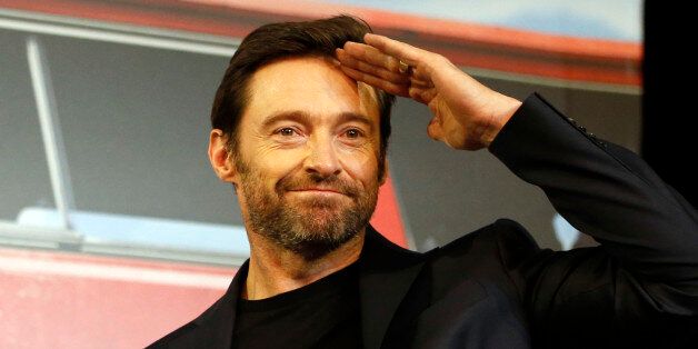 Actor Hugh Jackman greets to the media upon his arrival for a press conference for his new movie