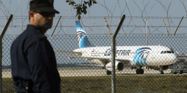 A policeman stands guard at Larnaca Airport near a hijacked Egyptair A320 , March 29, 2016.      REUTERS/Yiannis Kourtoglou