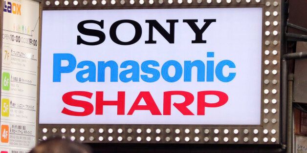 The brands' names of Japanese electronics makers, including Sharp, are displayed on a signboard of a retailer at Akihibara shopping district in Tokyo, Saturday, April 2, 2016. The head of Foxconn says the Taiwanese contract manufacturer will turn around struggling Japanese electronics maker Sharp. The leaders of the two companies met Saturday in Japan to sign agreements for Foxconn to buy a 66 percent share in the 104-year-old Japanese firm.  (AP Photo/Shuji Kajiyama)