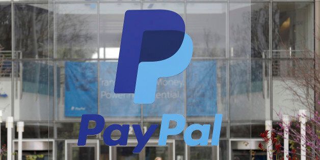 This March 10, 2015 photo shows a PayPal sign outside of the main entrance to an office building in San Jose, Calif. (AP Photo/Jeff Chiu)