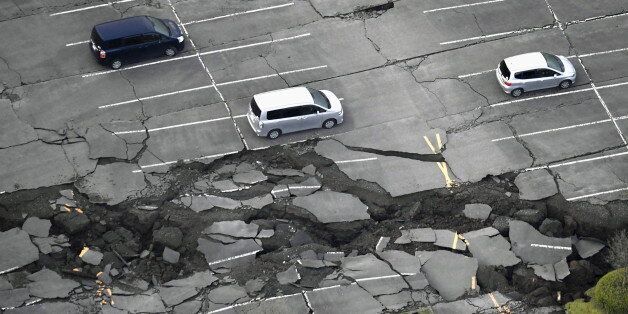 Cracks caused by an earthquake is seen at a parking lot in Minamiaso town, Kumamoto prefecture, southern Japan, in this photo taken by Kyodo April 16, 2016. Mandatory credit REUTERS/Kyodo  ATTENTION EDITORS - FOR EDITORIAL USE ONLY. NOT FOR SALE FOR MARKETING OR ADVERTISING CAMPAIGNS. THIS IMAGE HAS BEEN SUPPLIED BY A THIRD PARTY. IT IS DISTRIBUTED, EXACTLY AS RECEIVED BY REUTERS, AS A SERVICE TO CLIENTS. MANDATORY CREDIT. JAPAN OUT. NO COMMERCIAL OR EDITORIAL SALES IN JAPAN.