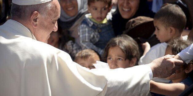 Pope Francis greets migrants and refugees at the Moria refugee camp near the port of Mytilene, on the Greek island of Lesbos, April 16, 2016. REUTERS/Filippo Monteforte/Pool