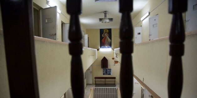 In this April 14, 2015 photo, a poster of Jesus hangs in the now empty Garcia Moreno Prison, during a guided tour for the public in Quito, Ecuador. After prisoners were transferred out in September, guides began giving 30 minute tours through the facility where tourists can get a first hand look at the cells where inmates slept, as well as the common areas. (AP Photo/Dolores Ochoa)