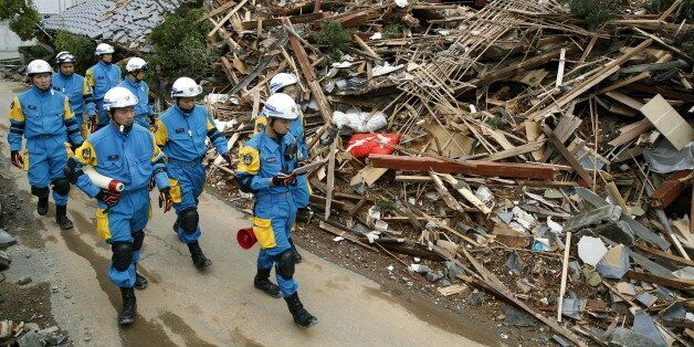 Police officers check a collapsed house after an earthquake in Mashiki town, Kumamoto prefecture, southern Japan, in this photo taken by Kyodo April 17, 2016. Mandatory credit REUTERS/Kyodo  ATTENTION EDITORS - FOR EDITORIAL USE ONLY. NOT FOR SALE FOR MARKETING OR ADVERTISING CAMPAIGNS. THIS IMAGE HAS BEEN SUPPLIED BY A THIRD PARTY. IT IS DISTRIBUTED, EXACTLY AS RECEIVED BY REUTERS, AS A SERVICE TO CLIENTS. MANDATORY CREDIT. JAPAN OUT. NO COMMERCIAL OR EDITORIAL SALES IN JAPAN.